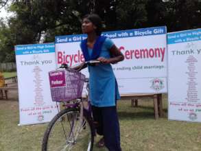 Recipient girl ready to go with the bicycle gift