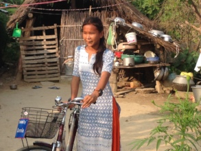 Bicycle recipient girl in her house premises