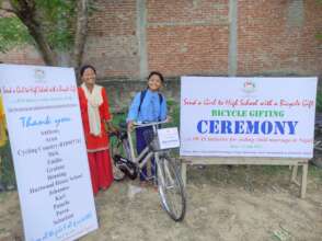 A bicycle recepient girl with her parent