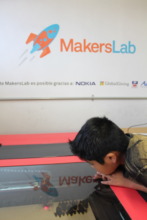 Emiliano looking the laser cutter working