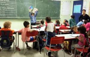 Child reads to his class