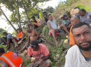 Men taking part in a village cleanup