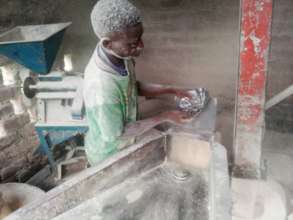 Grading the meal rice is a dusty job!