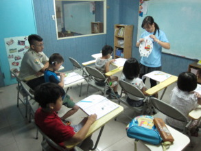 The teacher is teaching them about ' time' .