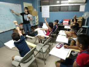 Children raise hands and wait to answer.