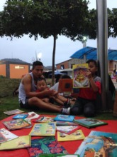 Father and son enjoying stories in the park
