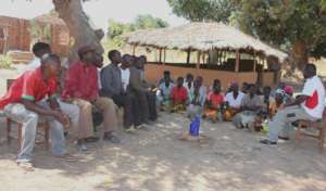 New COMACO farmers listening to a Lifeplayer