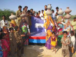 The happy women with pots of fresh drinking water