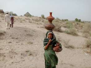A woman with two pitchers on her head