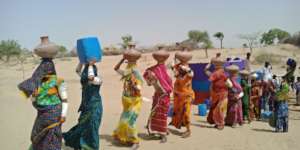 Women with pitchers of sweet drinking water.