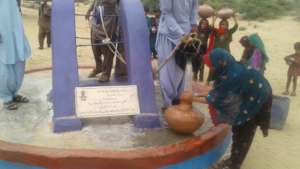 A woman filing her water pitcher