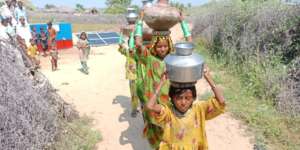 Girls Going Home after Filling Their Pots