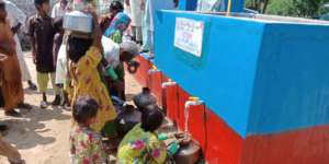 People Filling Their Pots With Water