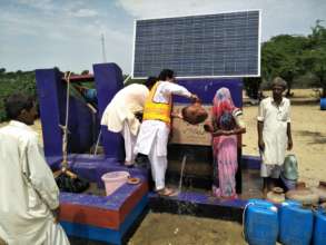 Woman getting water from the well.