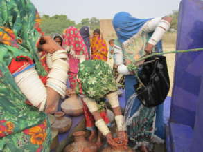 Water pitchers being filled by the women of thar
