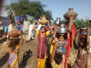 Children Happy after filling their Pots with Water