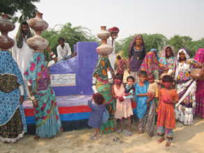 Women and children with water pots on their head