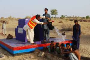 young boys are jubilant bathing from new well