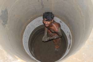 laborer is digging a new well manually