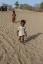 young child came running to get the sweets in Thar