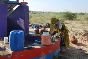 young woman is filling her waterpot.
