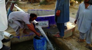 Water cans being filled from the well.