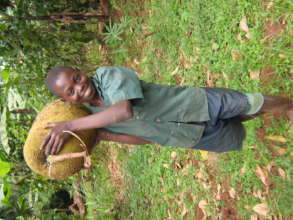 Ronald carrying jackfruit from the farm to HOH