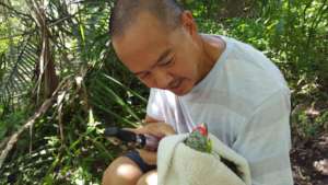 Dr Duane checking eyes of the red lored