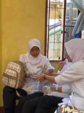 Student nurses examine children at school