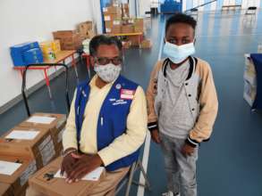 Foster Grandparent distributing tablets