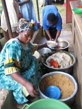 Kamida Wosukira, WMI borrower, caters lunch for a group meeting