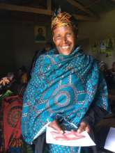 A new borrower holds her 200,000 shilling loan