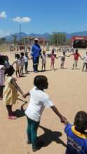 Volunteer and children at a rural pre-school.