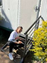 Volunteer paints step railing on Mandela Day