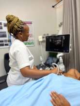 Sr Motswi doing ultrasound breast scan