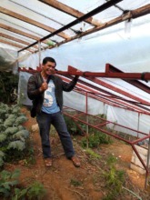 Farmer Smiles with his new Greenhouse