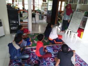 The children focus on Miss Vina's explaination