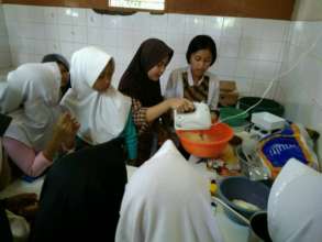 The children learning how to use mixer