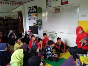 Miss Agnes reading the book for the children