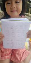 The student shows her hands writing work