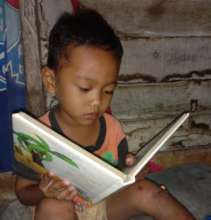 A first-grader practicing reading at home