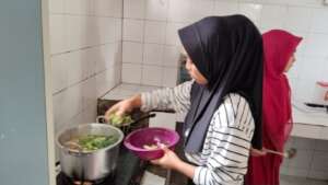 The parents cooking at YUM's kitchen