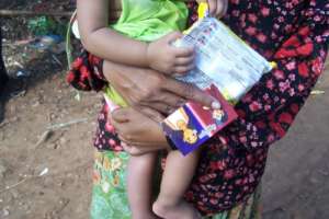 A mother holds a 'help card'