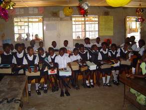 Scholarship recipients with their school supplies in the classro