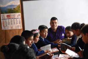 Jorge and his students working on a group project.