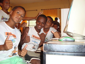 young kids in school uniforms happy at computer school
