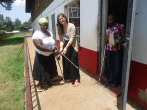 Global Giving Rep handing over elbow crutches