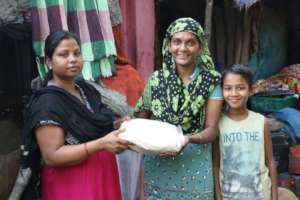 Shaheen (right) receives her food rations