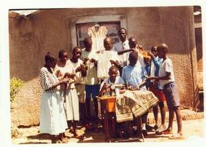 A group of children learning tailoring .