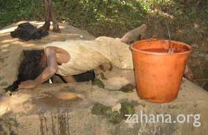 Girl gets water at Fiarenana’s communal well
